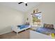 Cheerful bedroom featuring twin beds, a window seat, and fun wall art at 2660 Oneida Loop, Kissimmee, FL 34747