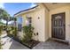 Dark brown front door with sidelights and a welcoming mat at 2660 Oneida Loop, Kissimmee, FL 34747