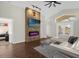 Open living area with a stone fireplace and large TV at 2660 Oneida Loop, Kissimmee, FL 34747