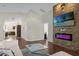 Living room with stone fireplace and view of kitchen at 2660 Oneida Loop, Kissimmee, FL 34747