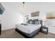 Large main bedroom with king-size bed, nightstands, and large window at 2660 Oneida Loop, Kissimmee, FL 34747