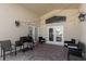 Covered patio with string lights, comfortable seating, and a grill at 2660 Oneida Loop, Kissimmee, FL 34747