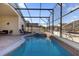Inviting screened pool and spa with brick pavers and outdoor seating at 2660 Oneida Loop, Kissimmee, FL 34747
