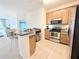 Modern kitchen with stainless steel appliances and wood cabinets at 2856 Oakwater Dr # 2856, Kissimmee, FL 34747
