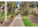 Well-maintained walking path through tropical landscaping at 2856 Oakwater Dr # 2856, Kissimmee, FL 34747