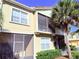 Tan two-story condo building with balconies and palm trees at 2856 Oakwater Dr # 2856, Kissimmee, FL 34747