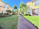 Landscaped community pathway with lush greenery at 2856 Oakwater Dr # 2856, Kissimmee, FL 34747