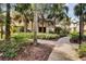 Paved pathway meandering through lush tropical foliage at 2856 Oakwater Dr # 2856, Kissimmee, FL 34747