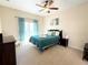 Comfortable bedroom with private balcony access and ceiling fan at 2856 Oakwater Dr # 2856, Kissimmee, FL 34747