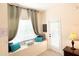 Cozy window seat with teal pillows and a wooden storage chest at 2856 Oakwater Dr # 2856, Kissimmee, FL 34747