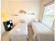 Bedroom with twin beds, ocean decor, and a large window at 2856 Oakwater Dr # 2856, Kissimmee, FL 34747