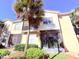 Two-story condo building with screened patio and lush landscaping at 2856 Oakwater Dr # 2856, Kissimmee, FL 34747
