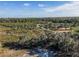 Aerial view of conservation land with a trail and lush vegetation at 3577 Dahlia Dr, Lake Hamilton, FL 33851
