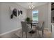 Dining area with gray chairs and black round table at 3577 Dahlia Dr, Lake Hamilton, FL 33851