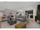 Open living room and kitchen with modern gray sofa and dark kitchen cabinets at 3577 Dahlia Dr, Lake Hamilton, FL 33851