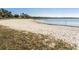 Lakefront sandy beach with grassy area at 3577 Dahlia Dr, Lake Hamilton, FL 33851