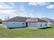 House exterior showcasing a large backyard with grassy lawn at 3618 Wellington Ln, Bartow, FL 33830