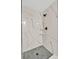 Large shower with marble-look walls and hexagonal floor tiles at 3618 Wellington Ln, Bartow, FL 33830