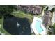 Aerial view of community pool, pond with fountain, and buildings at 4400 Thornbriar Ln # 201, Orlando, FL 32822