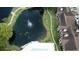 Aerial view showing pool, pond, and community buildings at 4400 Thornbriar Ln # 201, Orlando, FL 32822