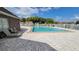 Community pool with lounge chairs and brick deck at 4400 Thornbriar Ln # 201, Orlando, FL 32822