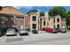 Exterior view of condo building and parking at 4400 Thornbriar Ln # 201, Orlando, FL 32822