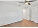 Simple bedroom with wood-look floors and ceiling fan at 5105 Forestgreen W Dr, Lakeland, FL 33811