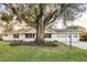 House with mature oak tree in front yard at 5105 Forestgreen W Dr, Lakeland, FL 33811