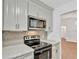 Modern kitchen with stainless steel appliances and marble countertops at 5105 Forestgreen W Dr, Lakeland, FL 33811