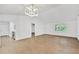 Open concept dining room with hardwood floors and modern light fixture at 5105 Forestgreen W Dr, Lakeland, FL 33811