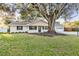 House with mature oak tree in front yard at 5105 Forestgreen W Dr, Lakeland, FL 33811