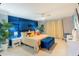 Main bedroom with blue accent wall and Mickey Mouse decor at 606 Jasmine Ln, Davenport, FL 33897