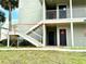 Exterior view of condo building's stairwell leading to unit entrance at 6142 Westgate Dr # 104, Orlando, FL 32835