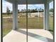 Covered lanai with sliding glass doors overlooking the backyard at 6817 Serpent Hawk Lane St, Howey In The Hills, FL 34737
