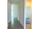 Bright hallway with tile flooring and doors to other rooms at 6817 Serpent Hawk, Howey In The Hills, FL 34737