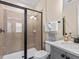Bathroom with walk-in shower and modern vanity at 8020 Shaker St, Kissimmee, FL 34747