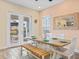 Dining area with farmhouse table and bench, adjacent to patio at 8020 Shaker St, Kissimmee, FL 34747