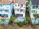 Aerial view of three-story townhouses with private pools and lush landscaping at 8020 Shaker St, Kissimmee, FL 34747