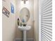 Small bathroom with pedestal sink, decorative accents, and shutters at 8020 Shaker St, Kissimmee, FL 34747