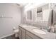 Bathroom with dual sinks, granite countertops, and large mirrors at 9036 Arbors Edge Trl, Windermere, FL 34786