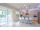 Modern kitchen with an island, stainless steel appliances, and white cabinets at 9036 Arbors Edge Trl, Windermere, FL 34786