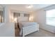 Bright bedroom featuring a white queen-size bed and neutral decor at 9036 Arbors Edge Trl, Windermere, FL 34786