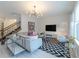 Bright living room featuring a sectional sofa, stylish rug, and large TV at 9036 Arbors Edge Trl, Windermere, FL 34786