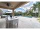 Covered patio with dining set and pool view at 9036 Arbors Edge Trl, Windermere, FL 34786