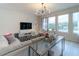 Spacious living room with sectional sofa, large TV, and glass coffee table at 9036 Arbors Edge Trl, Windermere, FL 34786