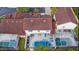Aerial view of homes with tile roofs, pools, and landscaped backyards at 148 Brunello Dr, Davenport, FL 33897