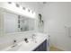 Modern bathroom featuring a dual sink vanity, stylish mirror, and contemporary light fixtures at 148 Brunello Dr, Davenport, FL 33897