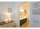View of the en-suite bathroom with a double vanity, modern fixtures, and navy blue cabinets at 148 Brunello Dr, Davenport, FL 33897