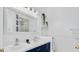 Modern bathroom with a double vanity sink and a navy blue cabinet at 148 Brunello Dr, Davenport, FL 33897