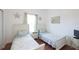 Two twin beds in a bedroom with white furnishings at 148 Brunello Dr, Davenport, FL 33897